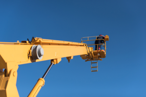 worker in bucket end of boom lift 