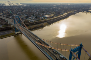 Aerial view of bridge with river and city below