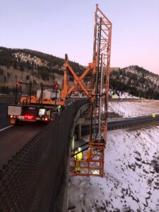 Orange Bridge inspection truck placed at side of bridge