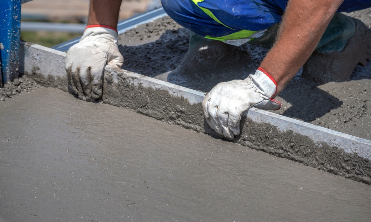 a construction worker smoothing concrete