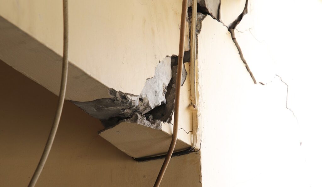 section of a bridge support with cracked concrete