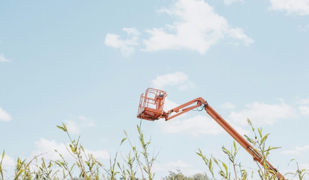 small basket boomlift over a field